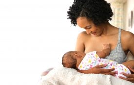 Benefits of Mother breastfeeding baby in living room