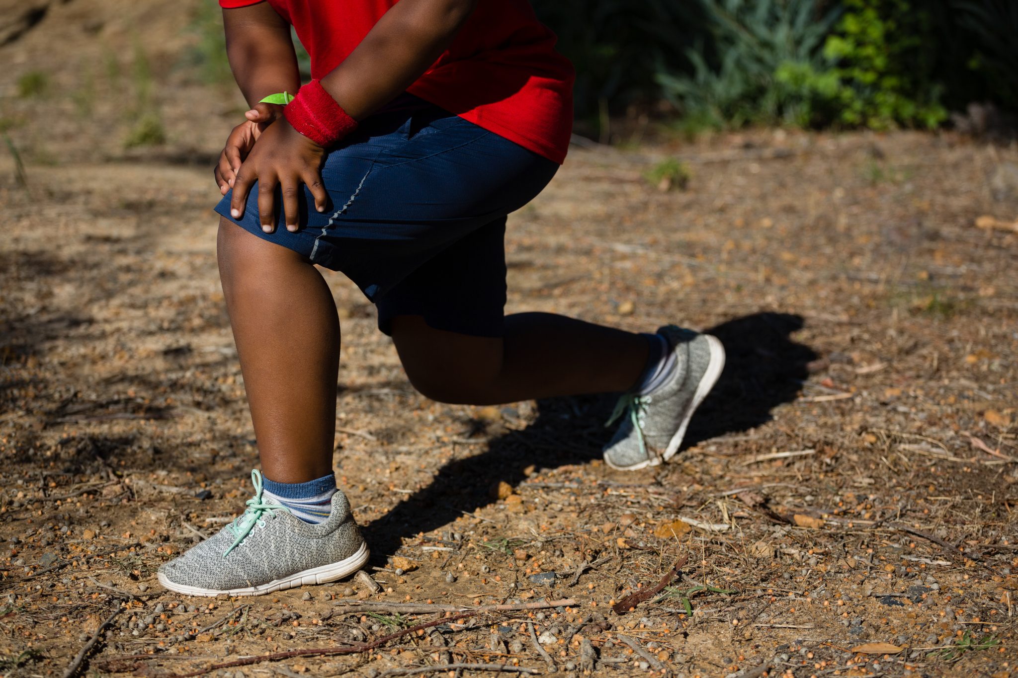 Boy performing stretching exercise during obstacle course training