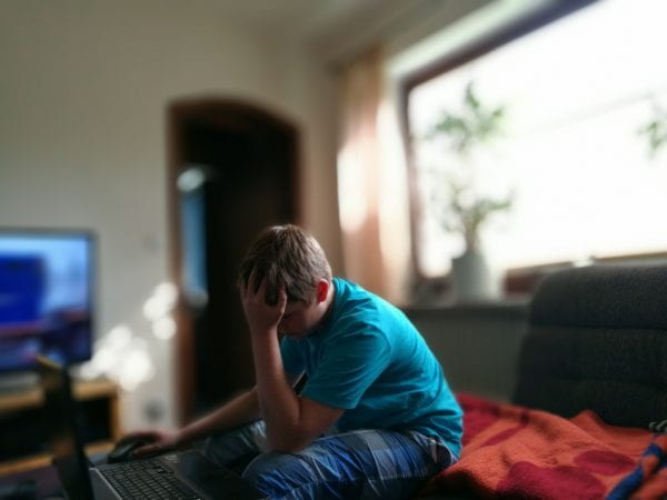 Teenage boy sitting on a couch