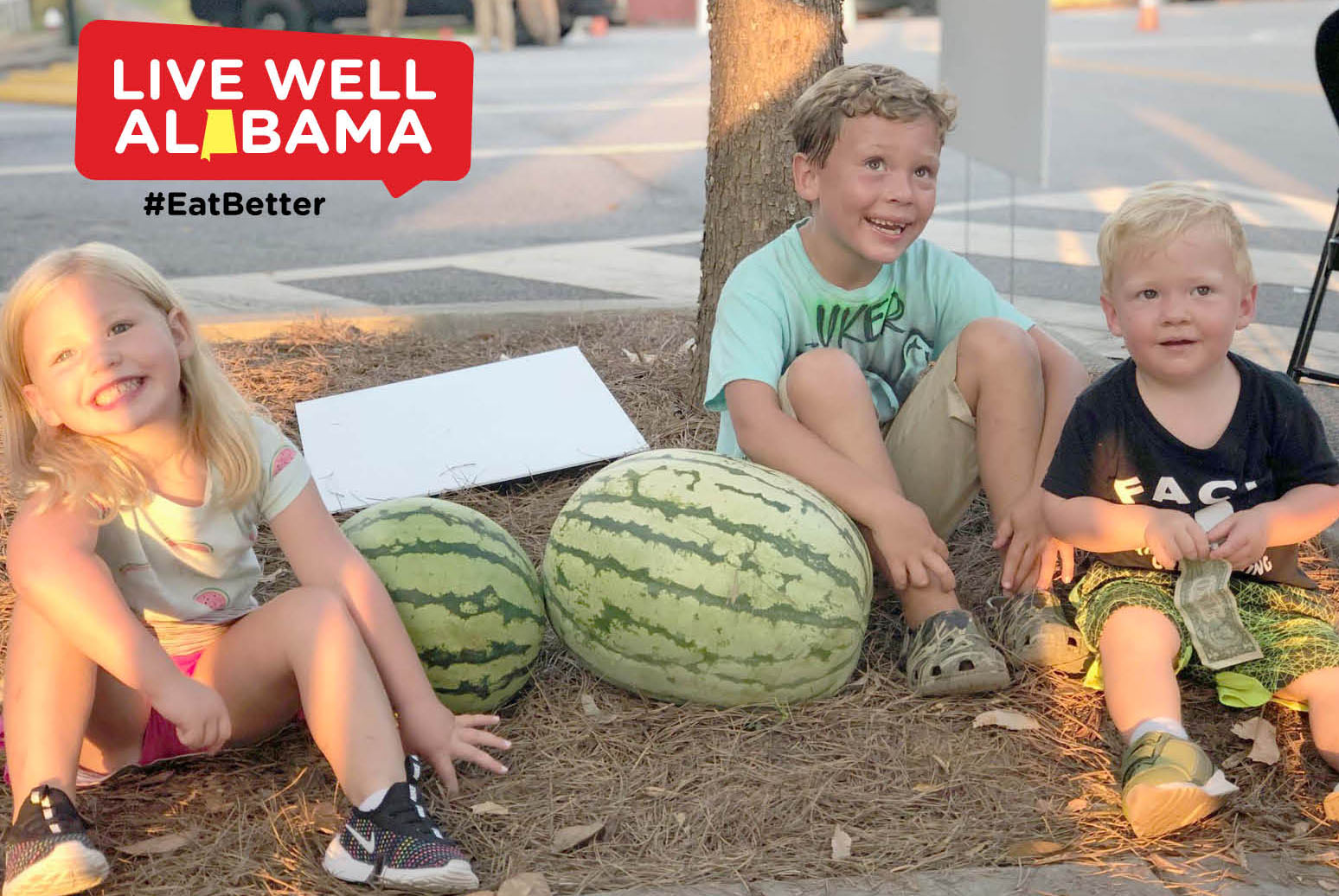 Kids sitting on ground smiling