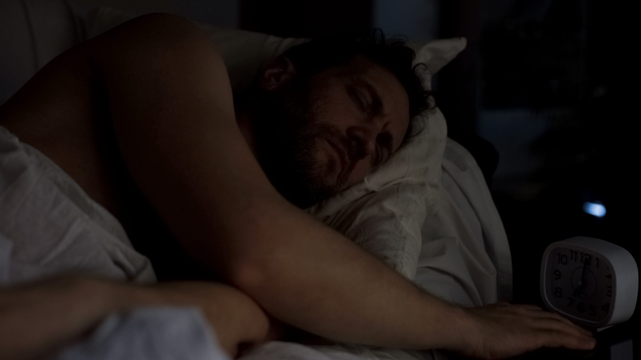 Sleeping man in a dark room