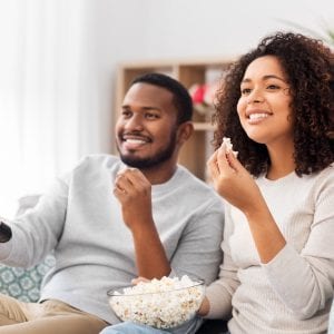 Black man and woman eating popcorn