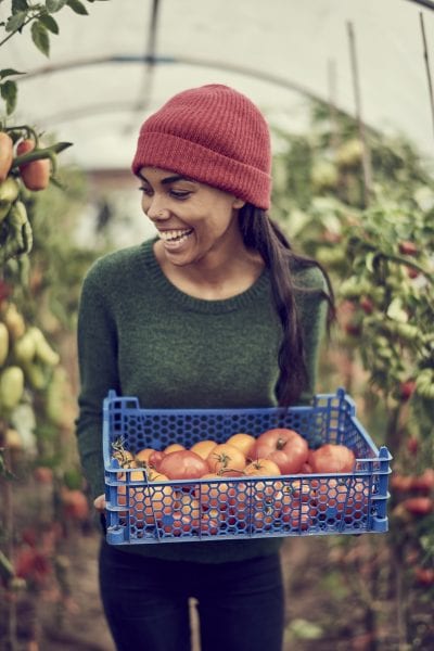 Young female holding tomatoes