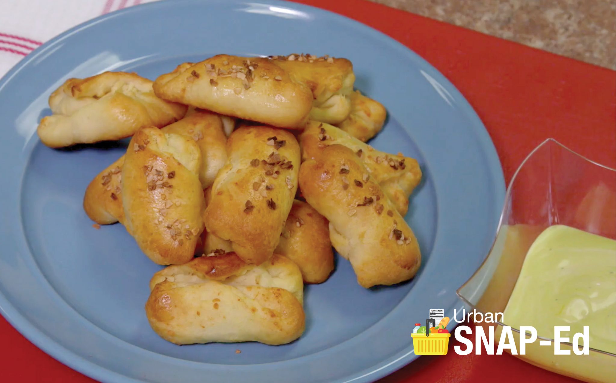 A plate of baked cheesy pretzels