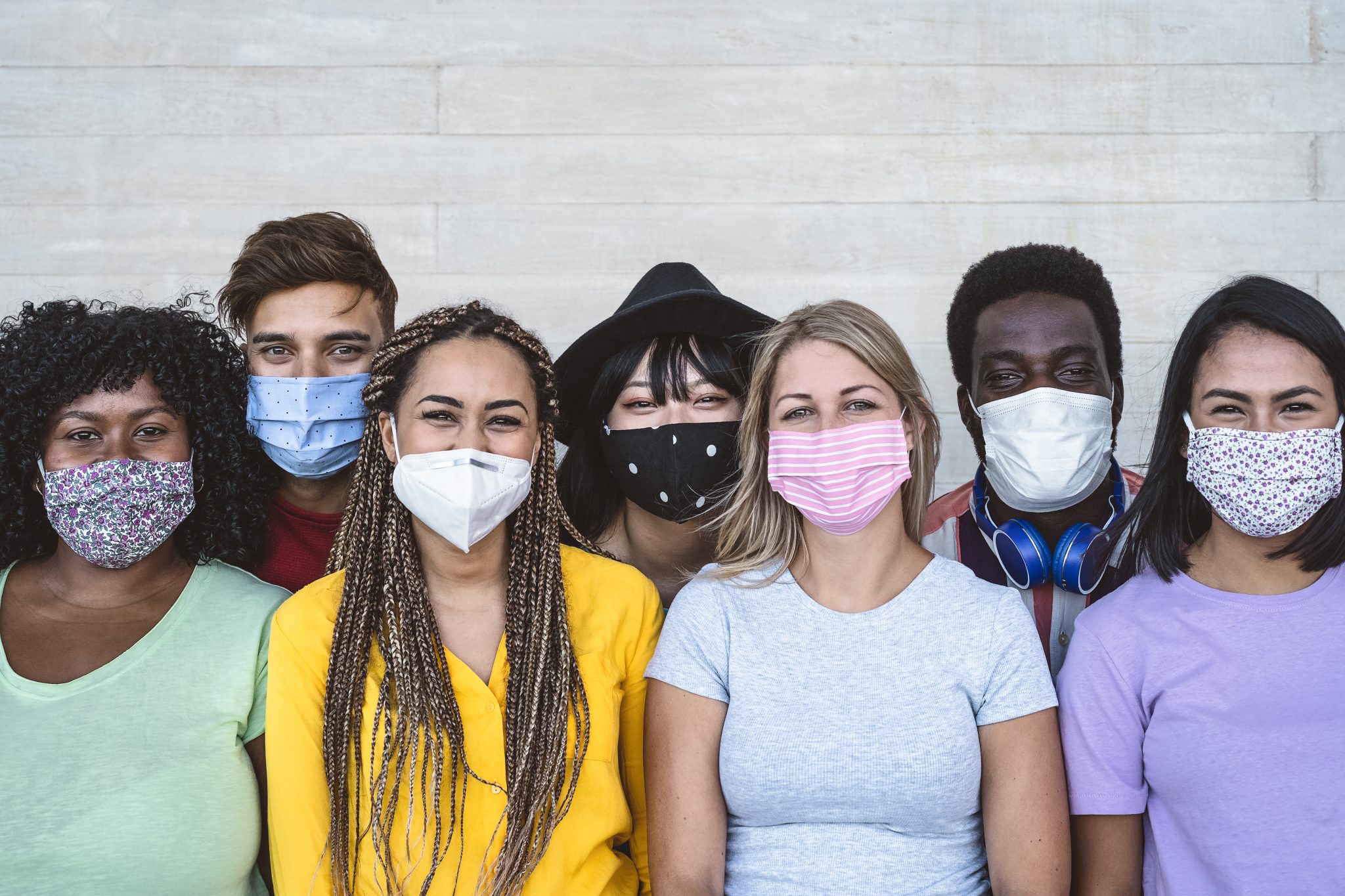 A diverse group of millennials wearing face masks