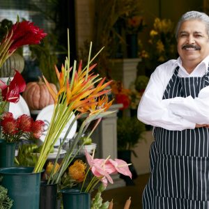 Portrait Of Male Florist Outside Shop Smiling To Camera.