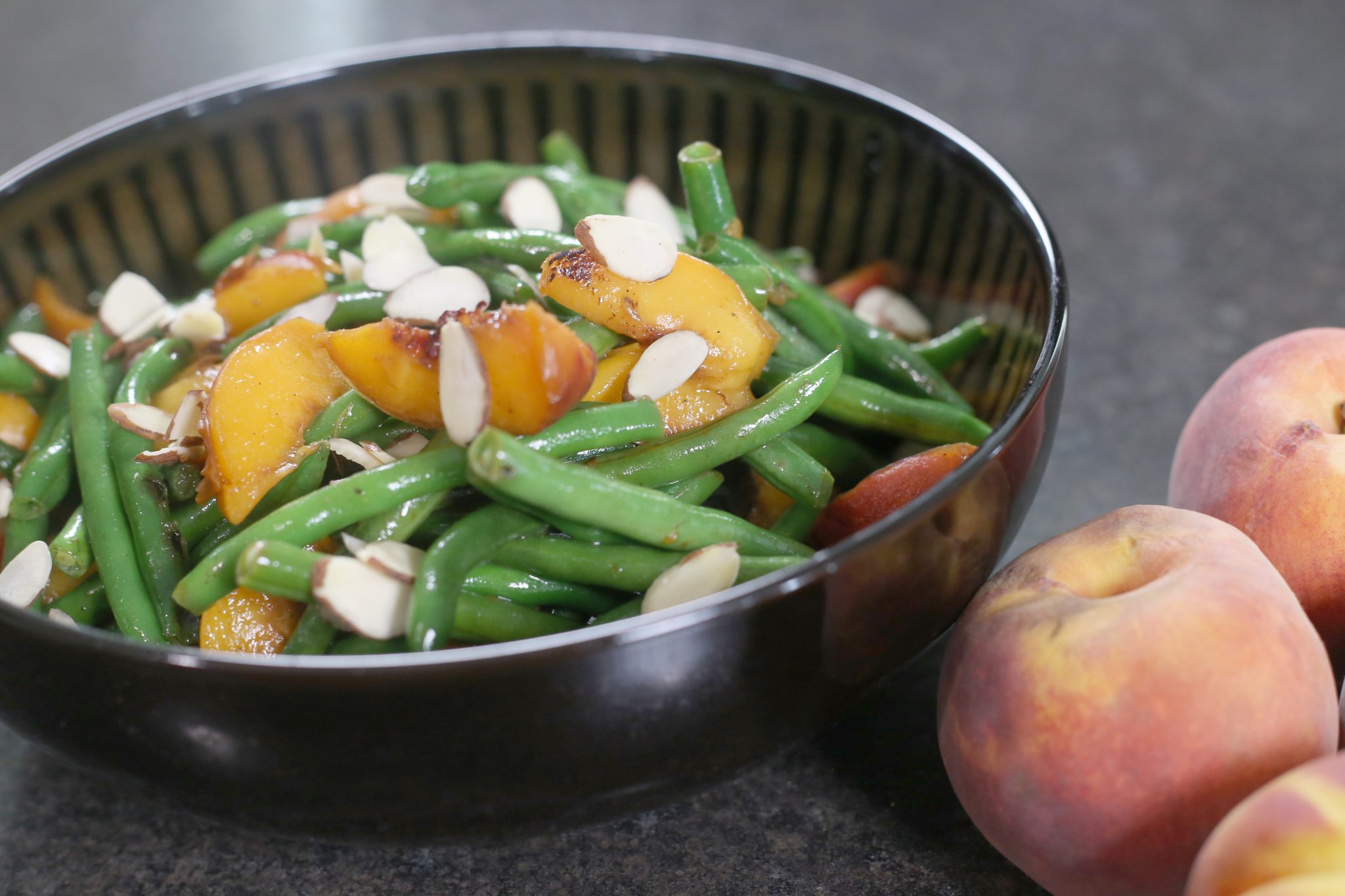 beans, peaches in black bowl