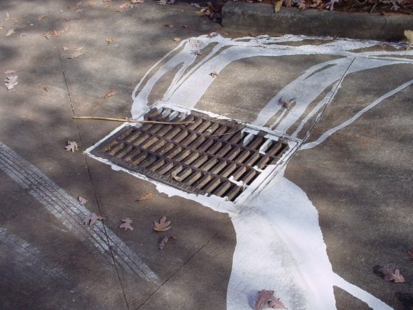 Figure 2. Paint is washed into a storm drain, depositing chemicals directly into local waterways.