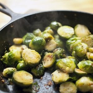 Brussels sprouts hot off the stove with steam rising from the pan