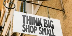 A sign that promotes buying local with the words Think Big Shop Small on it.