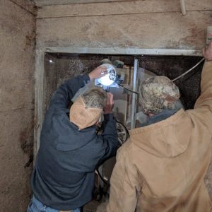 Figure 1. A broiler producer replacing a 1 horsepower (hp) electric motor on a tunnel ventilation fan