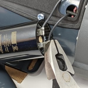 Figure 5. Electrically insulated pliers are used to remove the wiring connectors from the capacitor tabs. Do not use your fingers as the capacitor might be holding a charge.