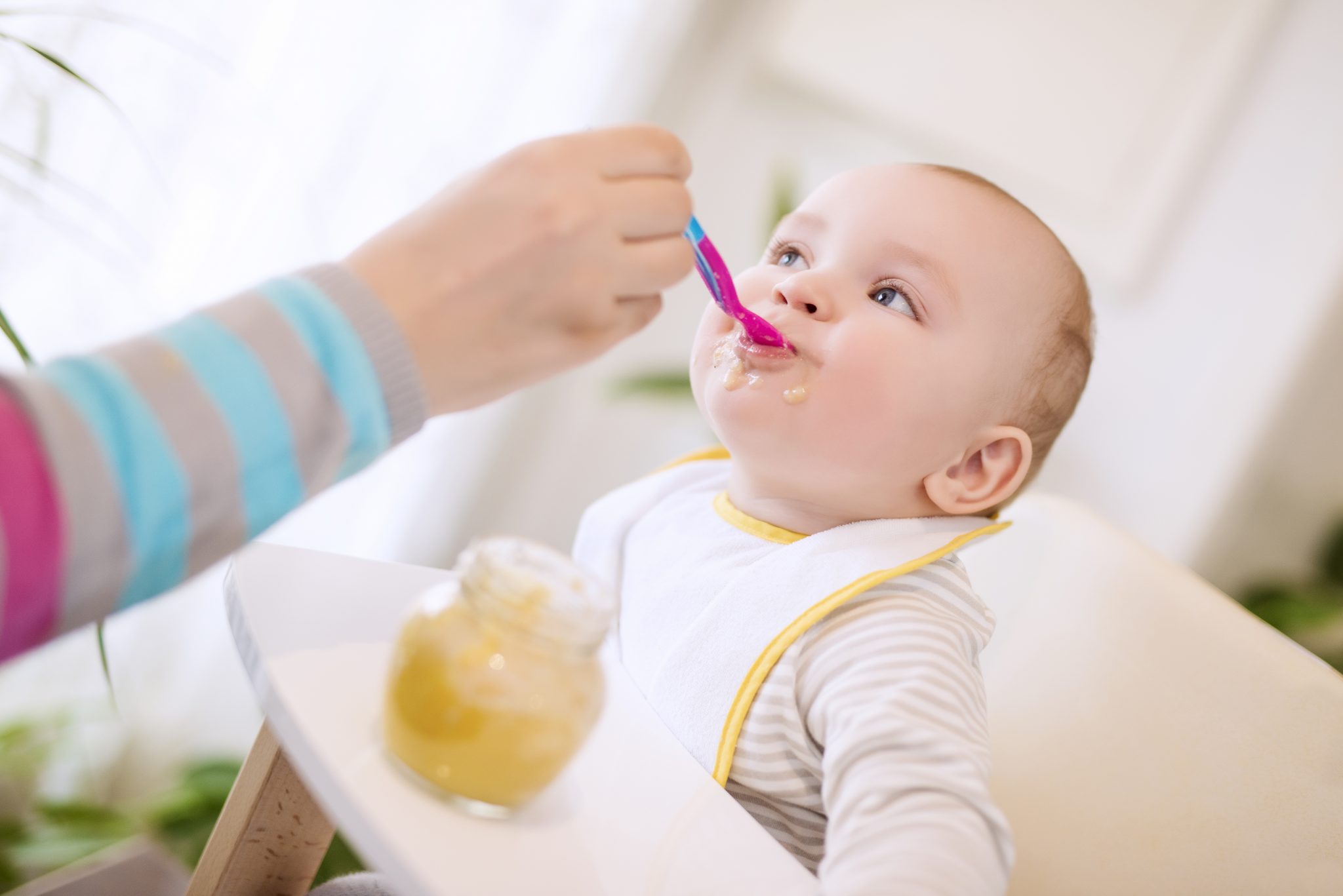 close up of a mother feeding her baby complementary foods