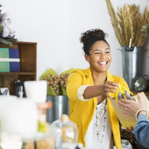 Young black saleswoman helping a customer