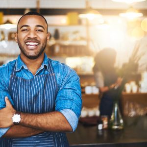 Young black man with an apron on