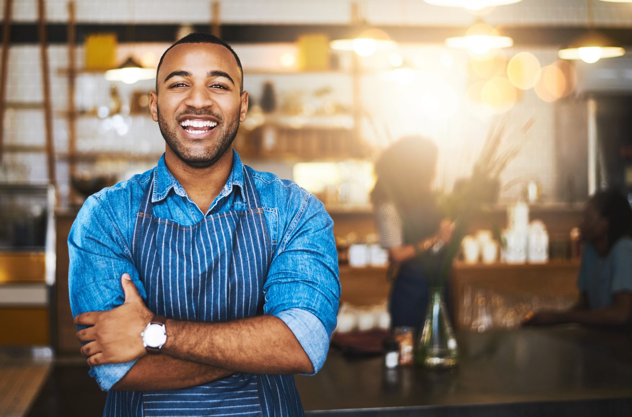 Young black man with an apron on
