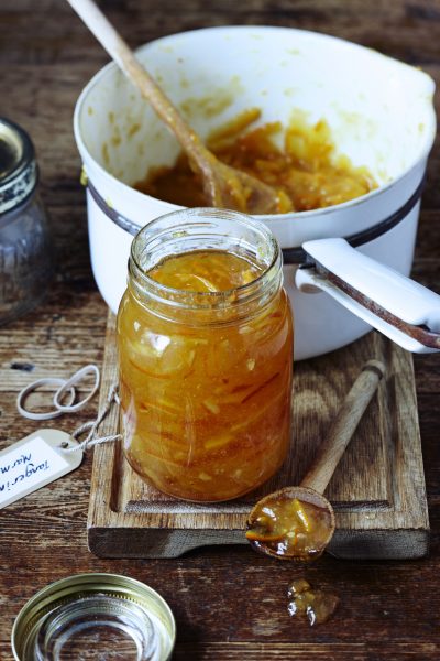 Jar of marmalade on table with pan