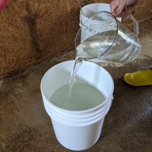 Figure 4. Using a gallon pitcher to identify where to mark for 5-gallons.