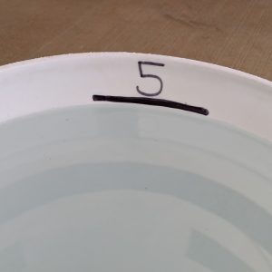 Figure 5. Use the top of the water line to mark the 5-gallon level.