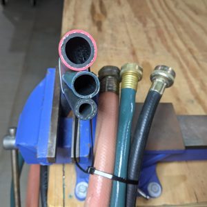 Figure 8. Medicator hose (11/16-inch ID), garden hose (5/8-inch ID), and residential washer hose (3/8-inch ID) showing the smaller hose diameters that can lead to restricted water flow.