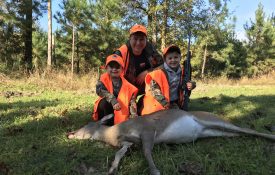 Dr. Mark Smith hunting deer with twin sons