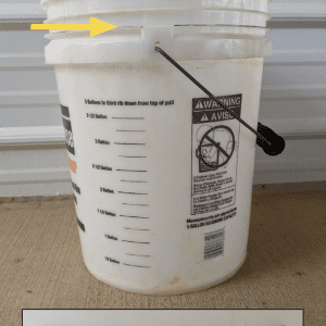 Figure 3. Yellow arrow shows the 5-gallon mark on this bucket. Beneath is the description of where the mark is located.