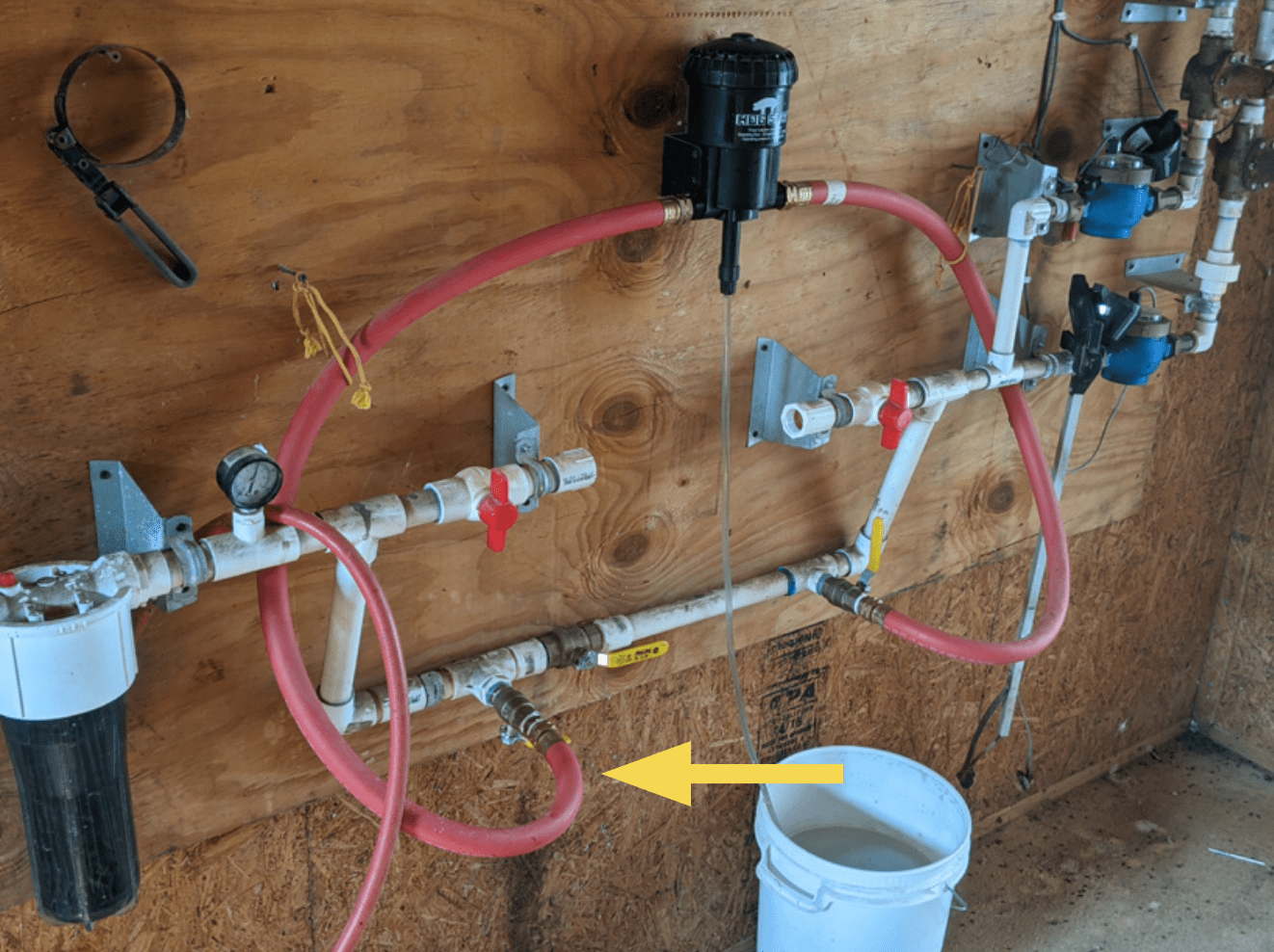 Figure 6. For this demonstration, the flow rate that is being evaluated is going into the medicator through a ball valve emphasized with the yellow arrow.