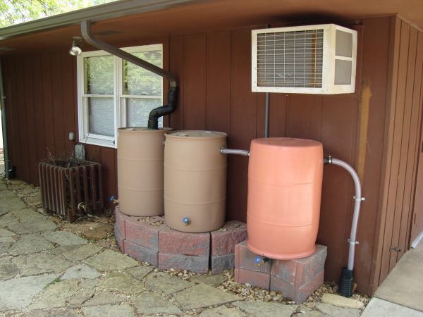 Figure 36. Rain barrels collecting water with gutter diverter, with linked connected overflow eventually directing excess into downspout