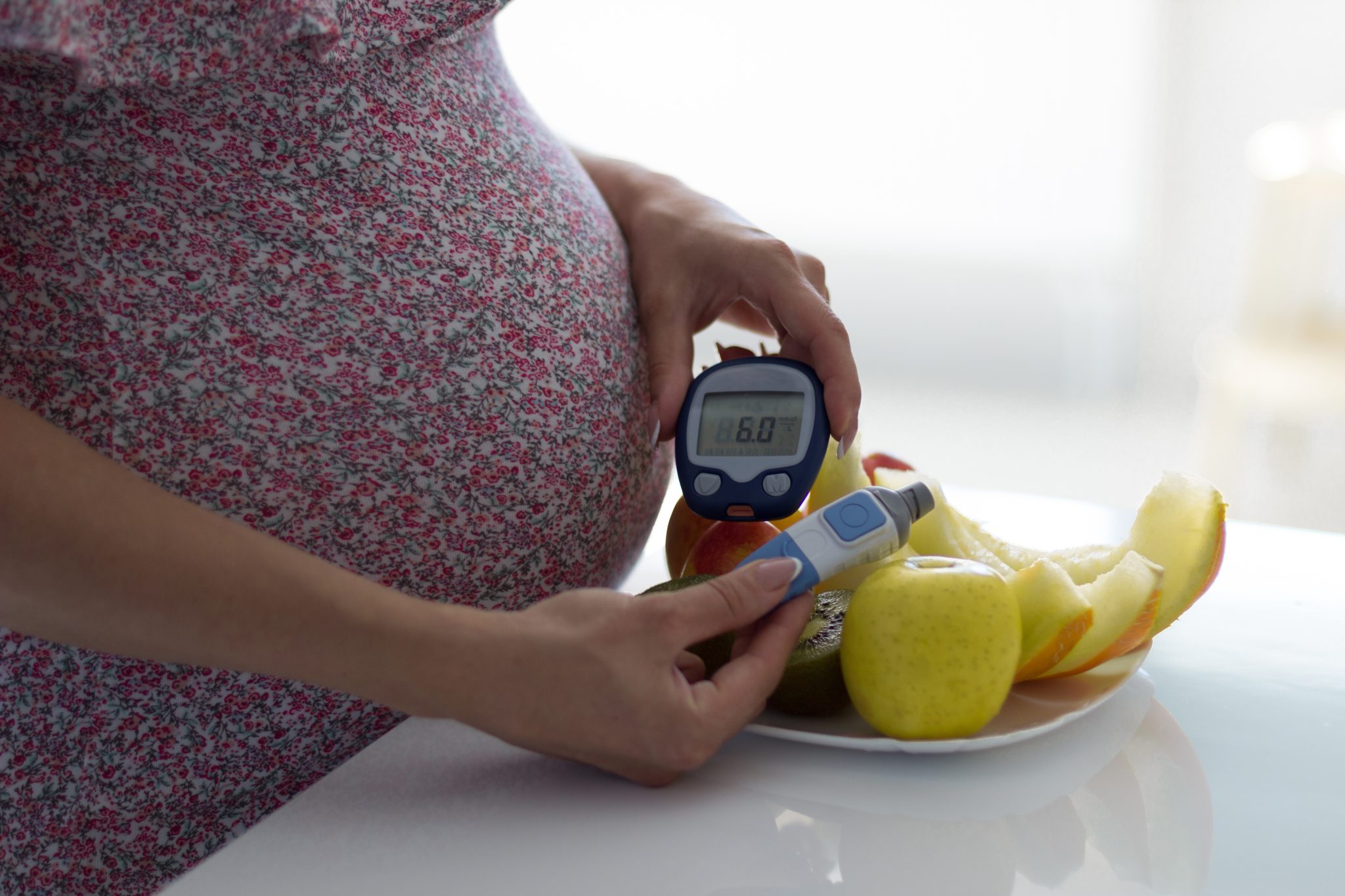 A pregnant woman with gestational diabetes checking her blood sugar.