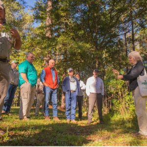 Nancy Loewenstein teaching loggers and foresters on invasive plant identification at a field demonstration PLM CFE workshop in 2021.