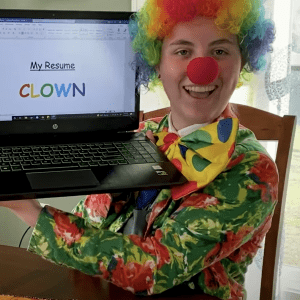 A clown working on a resume