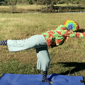 A clown doing yoga.