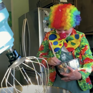 A clown cooking.