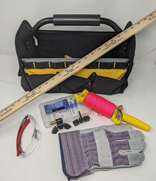 Figure 1. Tools to check fan pulley alignment: nylon construction string, yardstick, laser alignment tool, gloves, safety glasses, and hand tools.