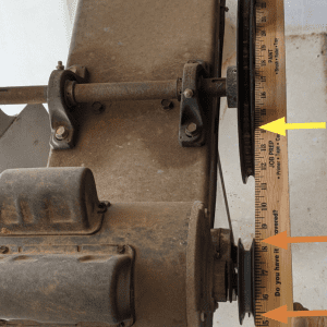 Figure 8. Yardstick method showing four points of contact and the pulleys in correct alignment after adjustment.