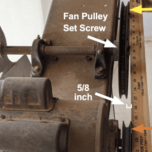 Figure 7. Yardstick method used on a fan where the pulleys are out of alignment (approximately 5/8 inch).