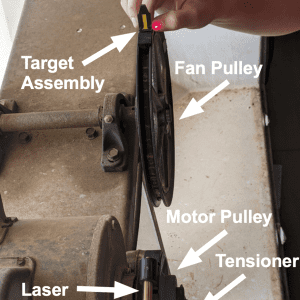 Figure 10. A laser alignment kit is placed on a tunnel fan to evaluate alignment. The laser body is on the motor pulley and the target body is on the fan pulley.