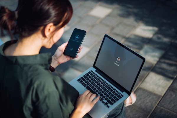 A woman on a phone and computer