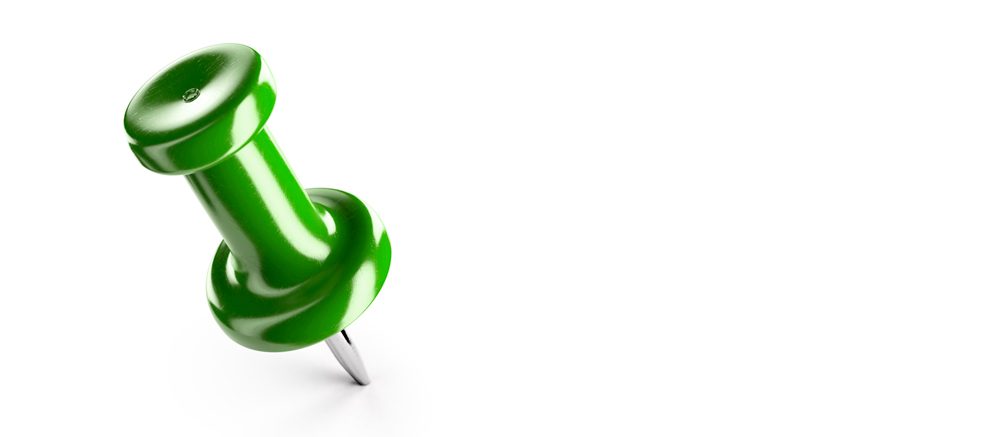 A green push pin on a white background.