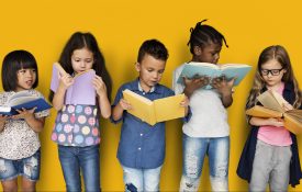 Children reading books on a yellow background