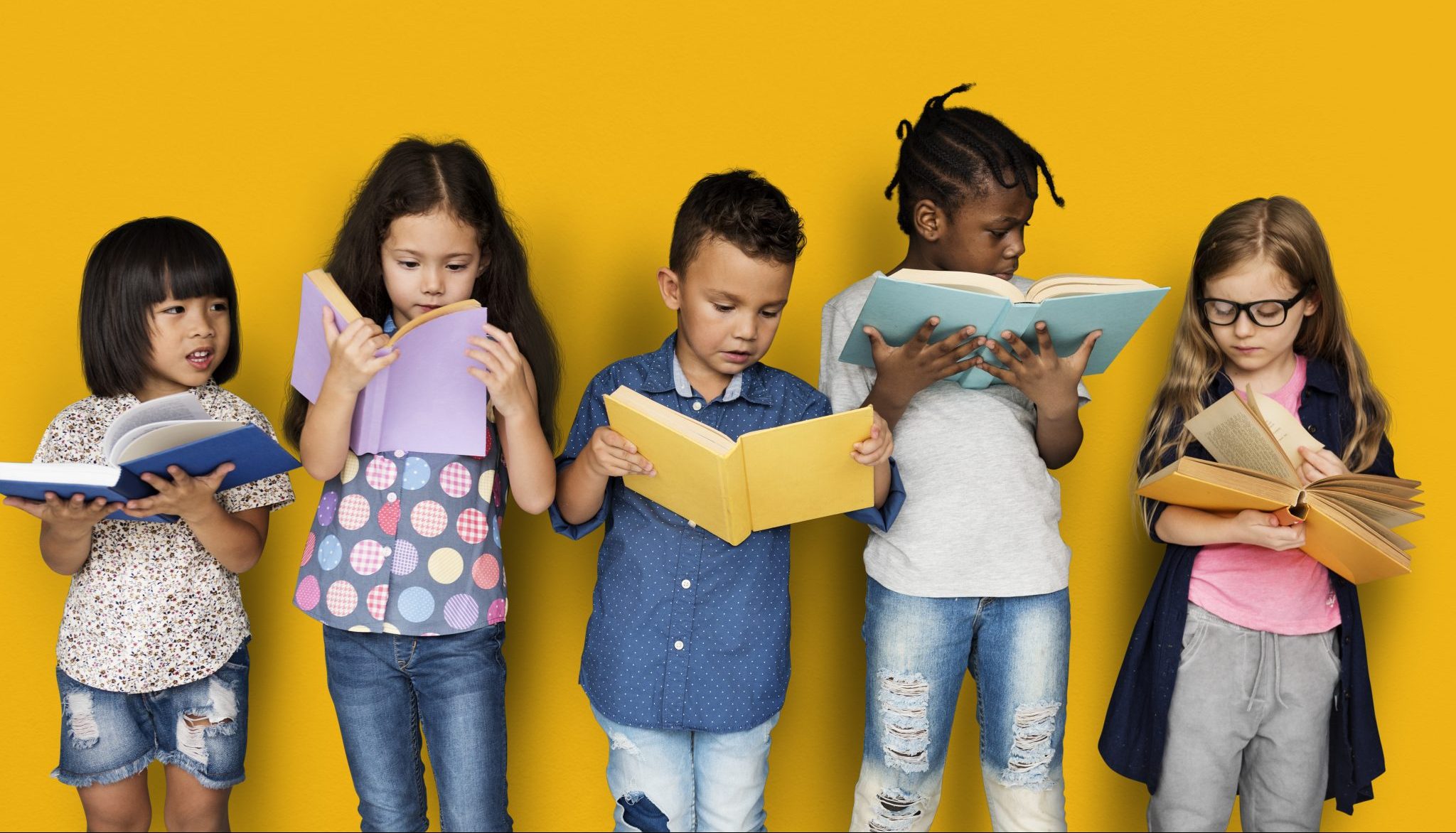 Children reading books on a yellow background