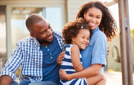 African-American family embracing each other