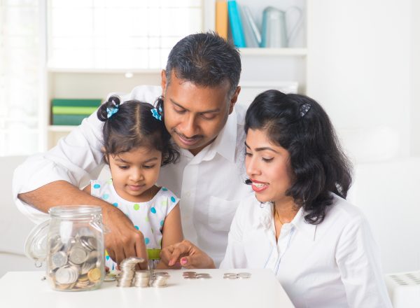 Indian family teaching about saving money