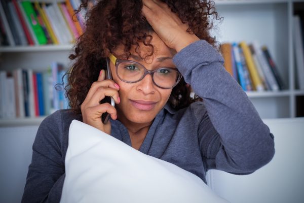 Young Black Woman Getting Bad News over the phone