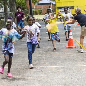 running to avoid getting color at The Abbeville Color Run
