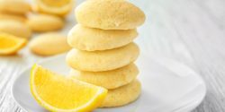 lemon wafer cookies on a plate with a lemon slice