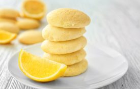 lemon wafer cookies on a plate with a lemon slice