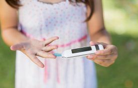A-young-girl-with-diabetes-checking-her-blood-sugar-levels