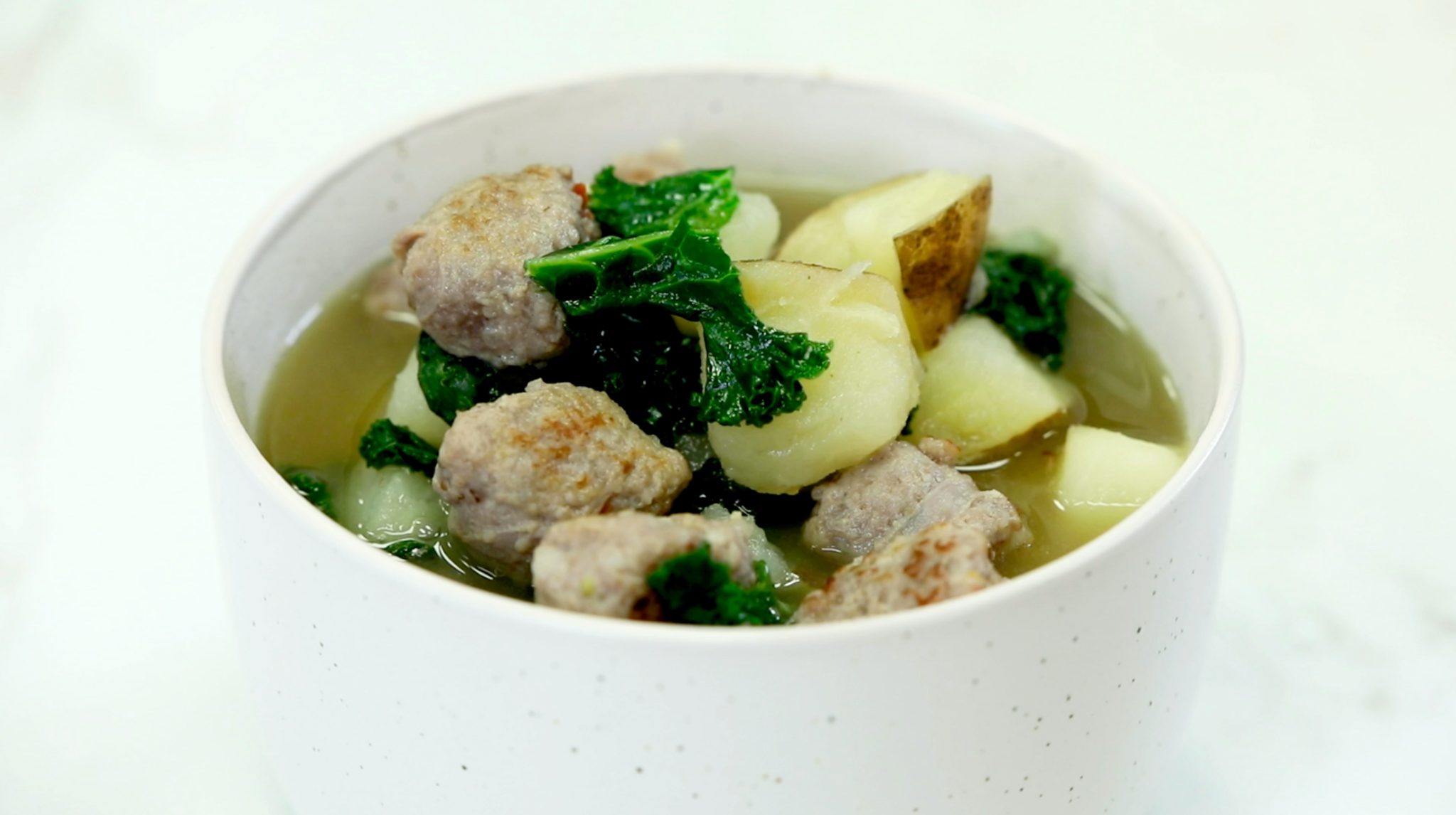 Get Your Greens Soup, kale, sausage, and potatoes in white bowl