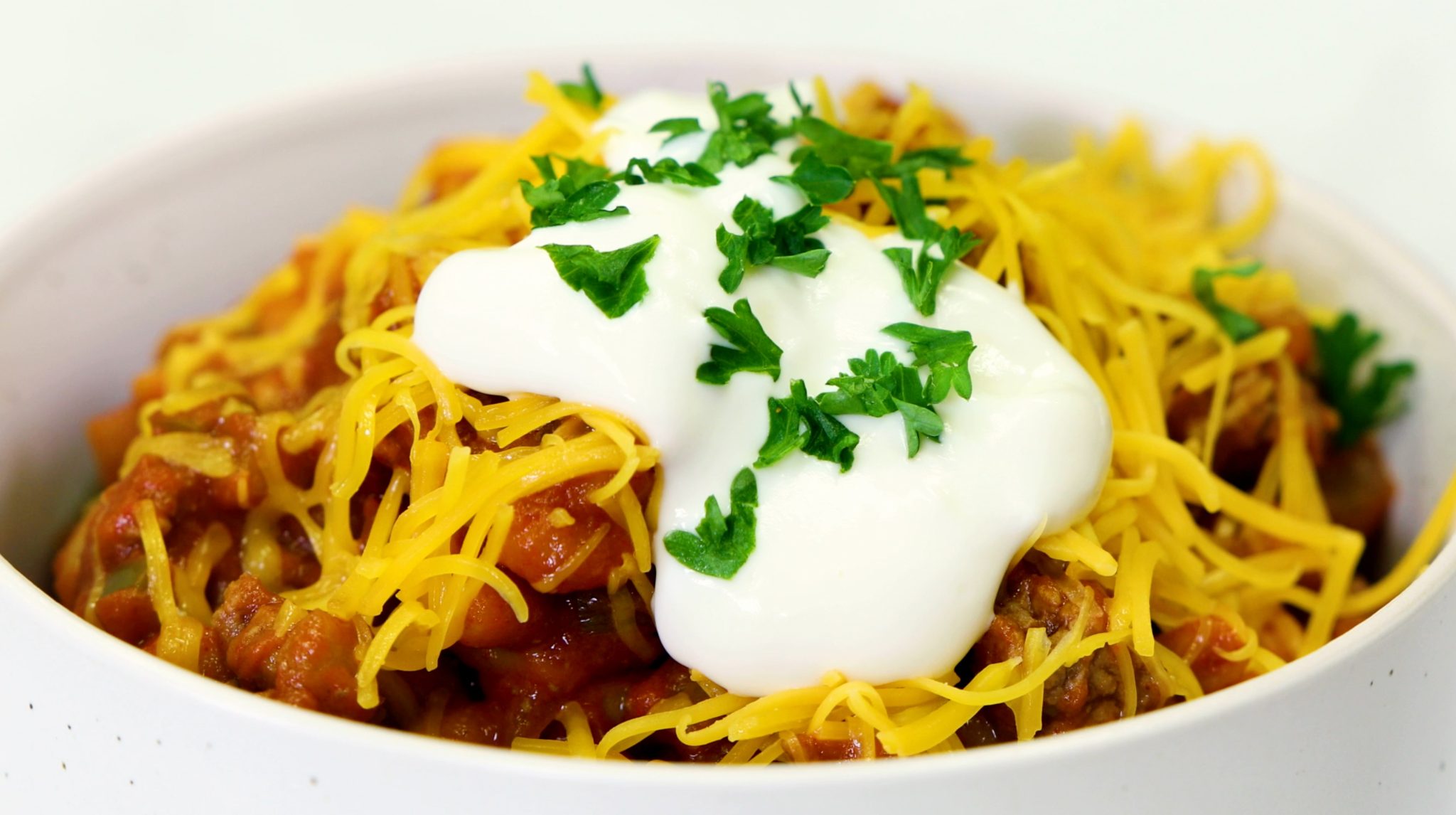 One Pot Chili Mac, cheese and sour cream over macaroni